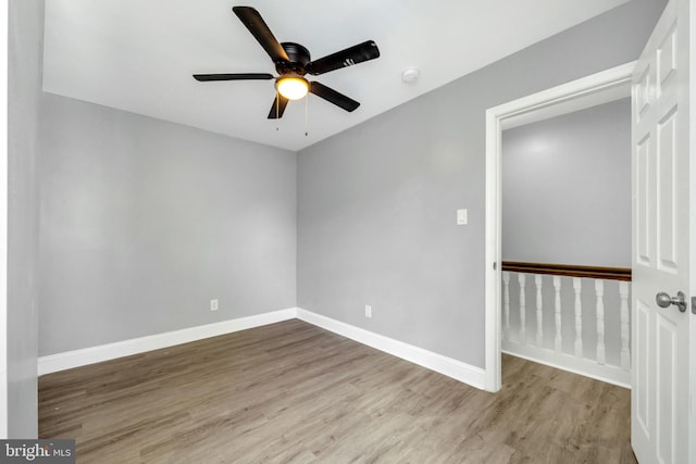 empty room featuring ceiling fan and light hardwood / wood-style flooring