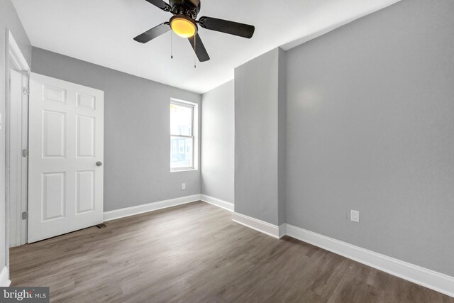 spare room featuring ceiling fan and dark hardwood / wood-style flooring