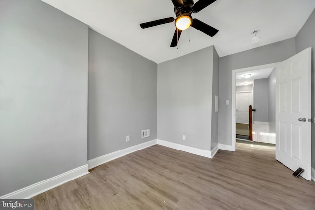 spare room with light hardwood / wood-style flooring and ceiling fan