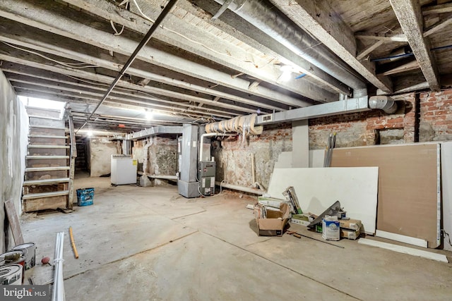 basement with washer / dryer and heating unit