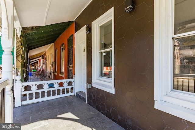 view of exterior entry featuring a porch