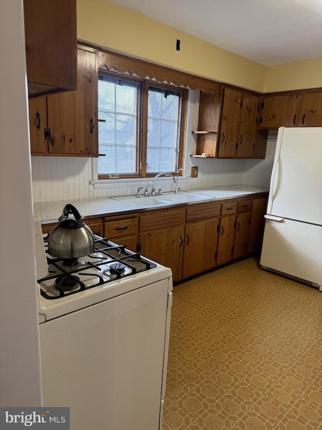 kitchen with sink and white appliances