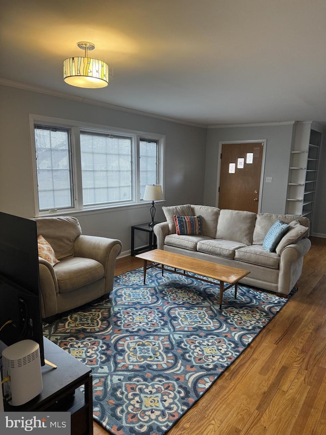 living room featuring hardwood / wood-style flooring and crown molding