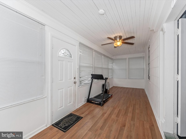 exercise room featuring ceiling fan, light hardwood / wood-style flooring, and wood ceiling