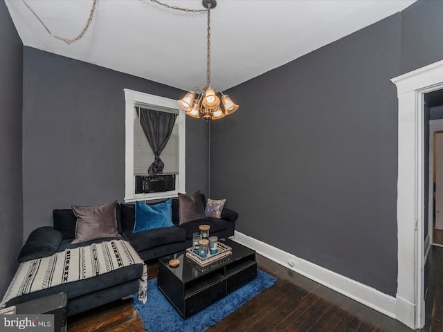 living room with hardwood / wood-style flooring and an inviting chandelier