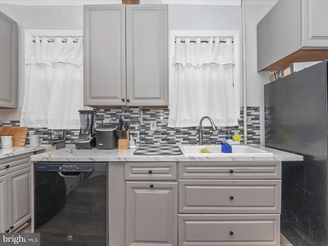 kitchen featuring gray cabinets, sink, black appliances, and backsplash