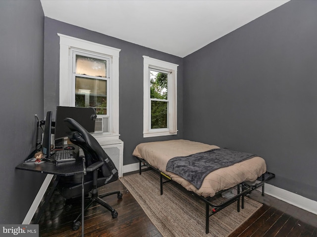 bedroom with dark hardwood / wood-style floors