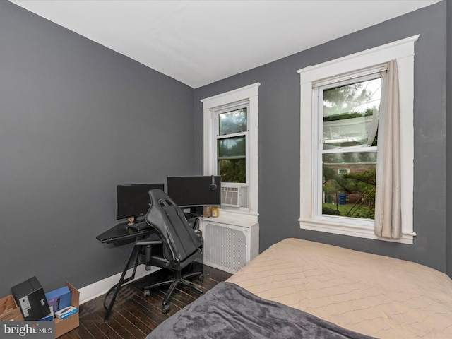 bedroom with dark wood-type flooring and cooling unit