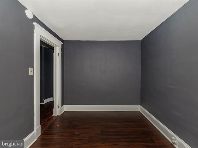 empty room featuring dark wood-type flooring