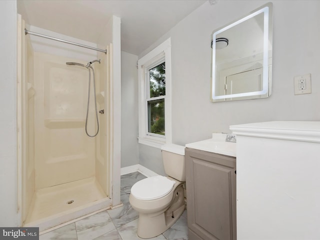 bathroom featuring vanity, toilet, and a shower