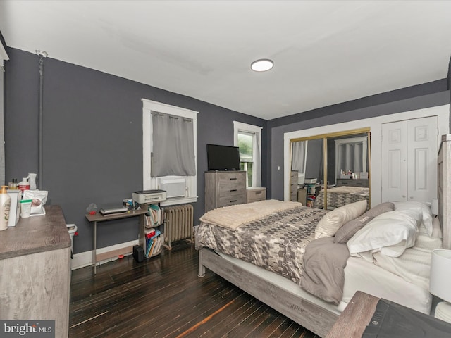 bedroom featuring radiator heating unit and dark hardwood / wood-style floors