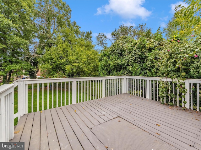 wooden deck with a lawn