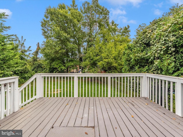 wooden deck featuring a yard