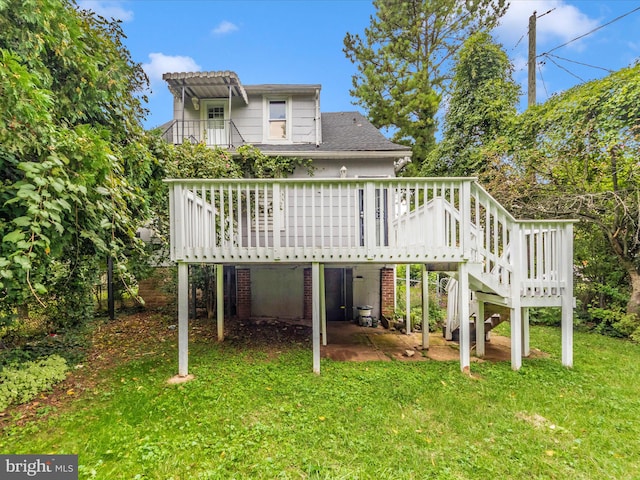 back of property with a yard, a wooden deck, and a pergola