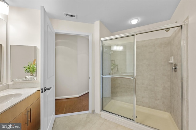 bathroom featuring tile patterned floors, vanity, and an enclosed shower