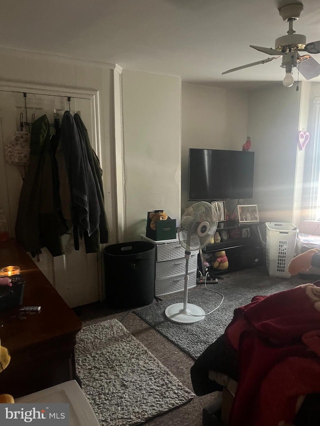 living room with ceiling fan and carpet