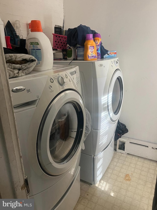 washroom featuring baseboard heating and washer and clothes dryer