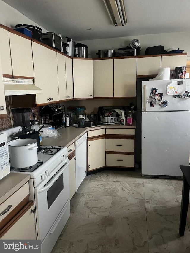 kitchen with white cabinets and white appliances