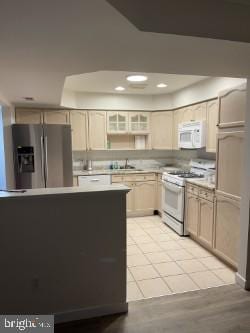 kitchen with sink, white appliances, and light wood-type flooring