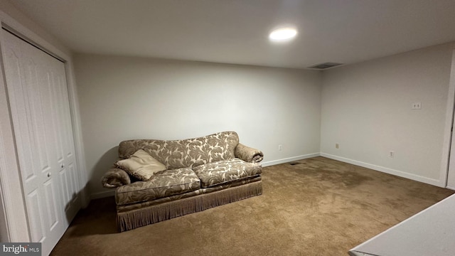 living area with dark colored carpet