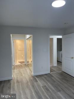 spare room with wood-type flooring