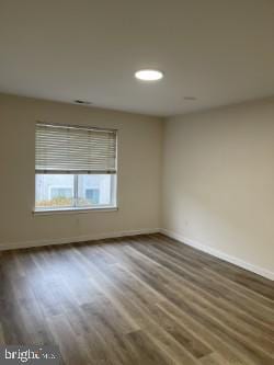 spare room featuring hardwood / wood-style floors