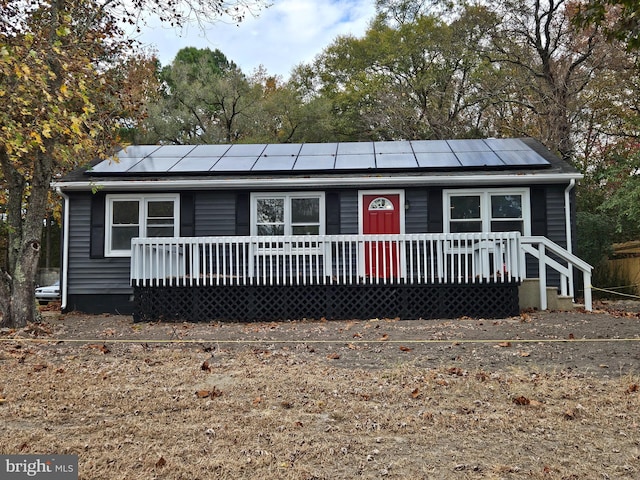 view of front of property featuring solar panels