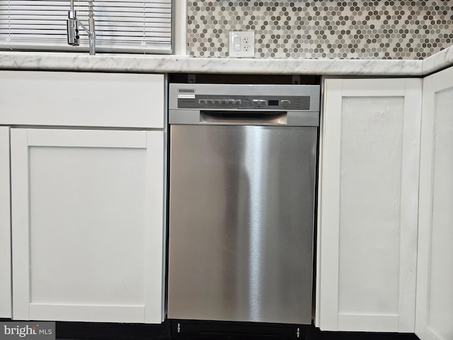 kitchen with dishwasher, decorative backsplash, and white cabinetry