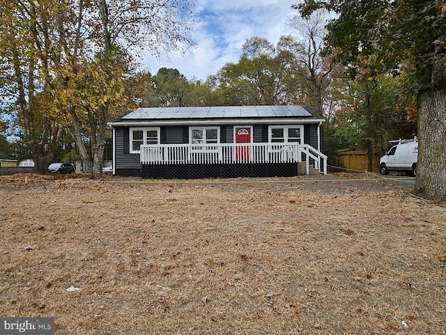 view of front facade with solar panels and a deck