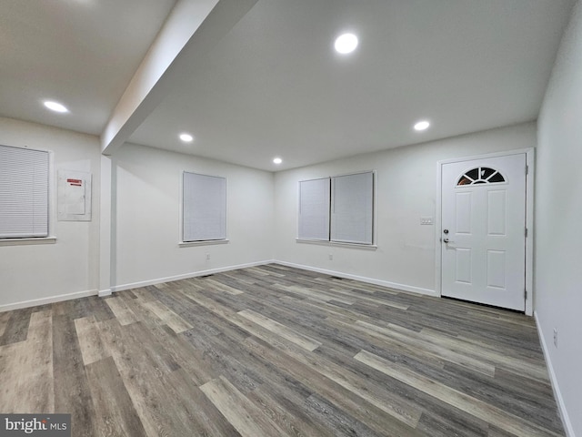 interior space featuring electric panel and wood-type flooring