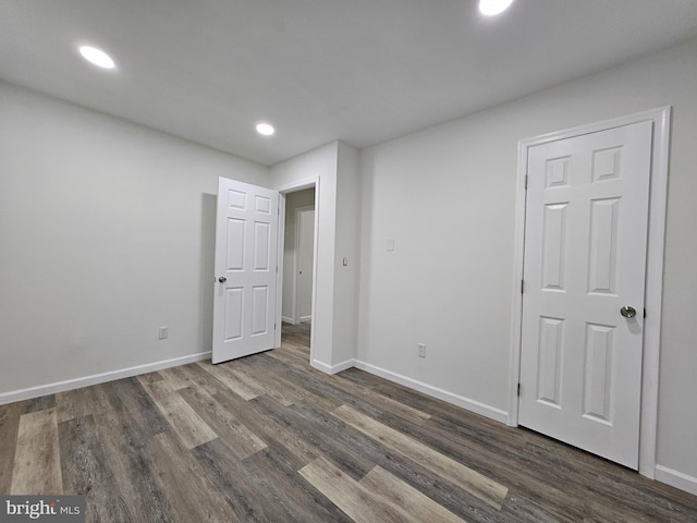 unfurnished bedroom featuring dark hardwood / wood-style floors