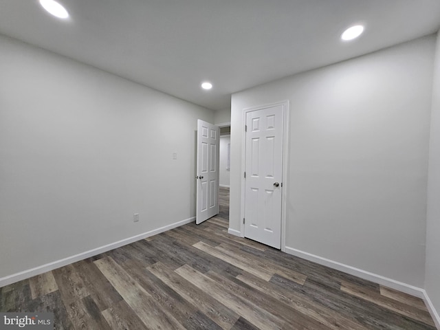 unfurnished room featuring dark hardwood / wood-style flooring