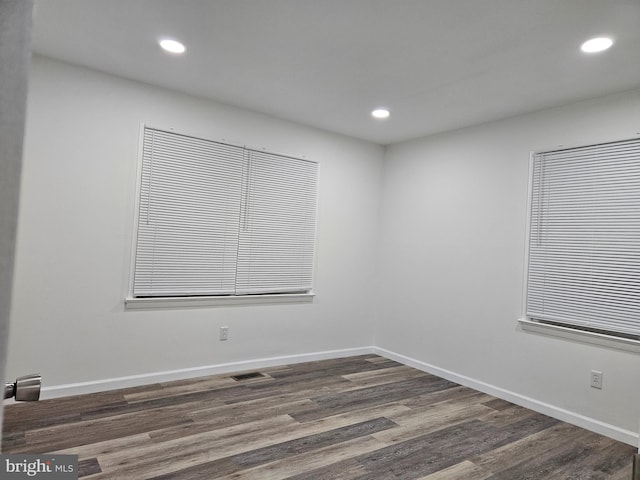 unfurnished room featuring dark wood-type flooring