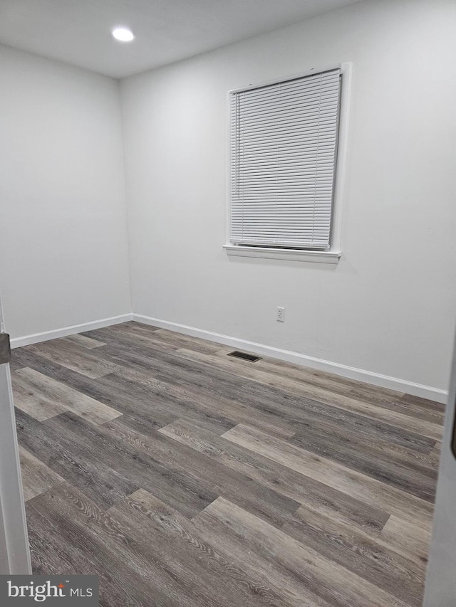 spare room featuring dark hardwood / wood-style flooring