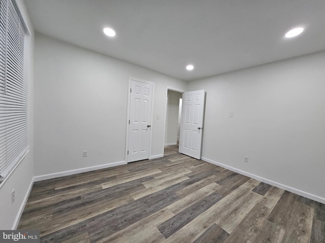 unfurnished bedroom featuring dark wood-type flooring