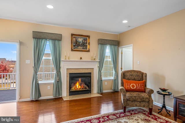 sitting room with hardwood / wood-style flooring and a healthy amount of sunlight