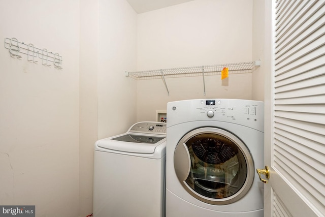 clothes washing area featuring washer and clothes dryer