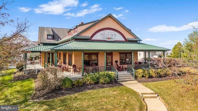 view of front of home with a porch and a front lawn