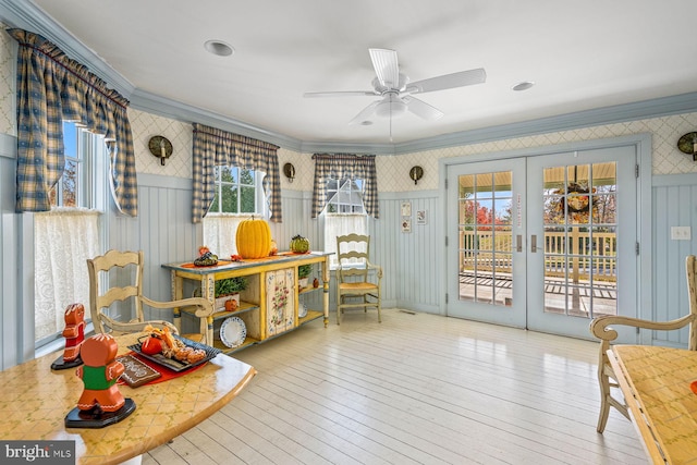 sitting room featuring french doors, light wood-type flooring, and ceiling fan