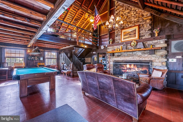 playroom featuring a stone fireplace, pool table, wood walls, high vaulted ceiling, and beam ceiling