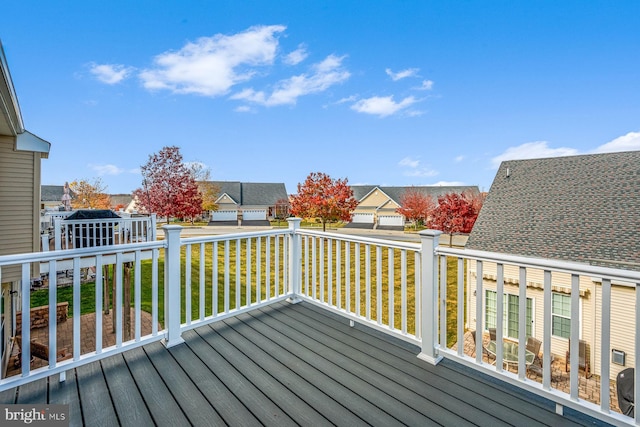 wooden deck with a lawn