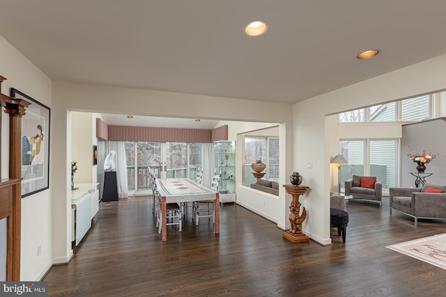 dining area featuring dark wood-type flooring and a healthy amount of sunlight