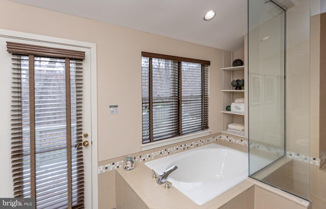 bathroom featuring tiled tub