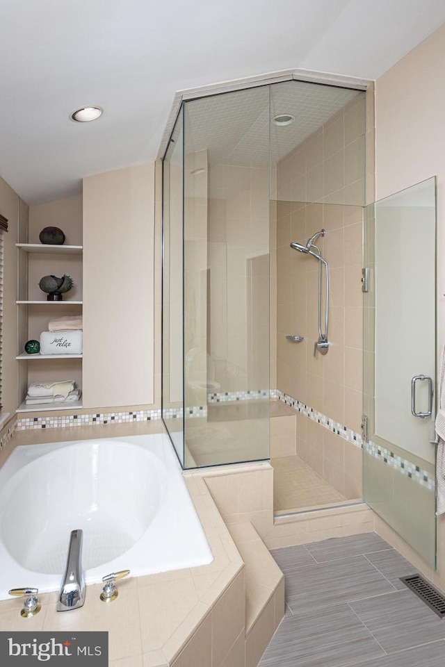 bathroom featuring separate shower and tub and tile patterned flooring