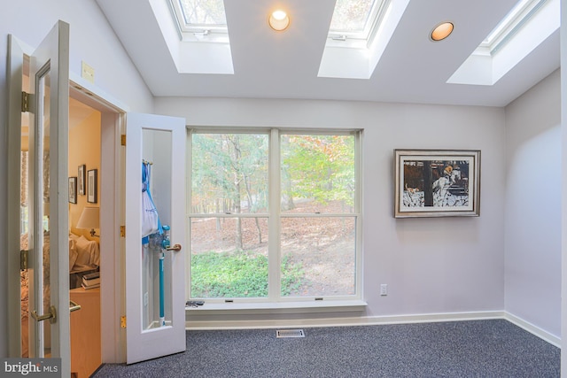 spare room with carpet floors and lofted ceiling