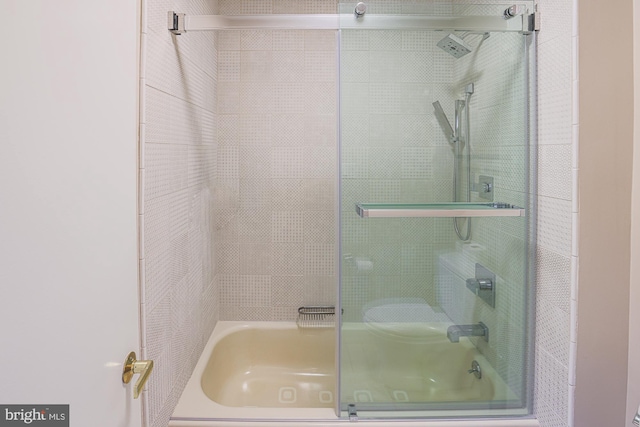 bathroom featuring combined bath / shower with glass door