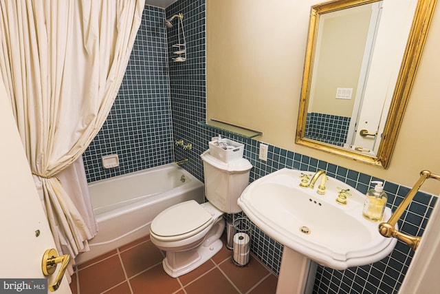 full bathroom featuring tile patterned flooring, toilet, tile walls, and shower / tub combo