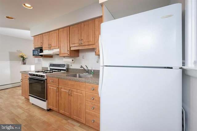 kitchen with a baseboard heating unit, tasteful backsplash, light wood-type flooring, sink, and white appliances