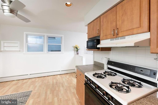 kitchen featuring baseboard heating, decorative backsplash, white range with gas cooktop, and light hardwood / wood-style flooring