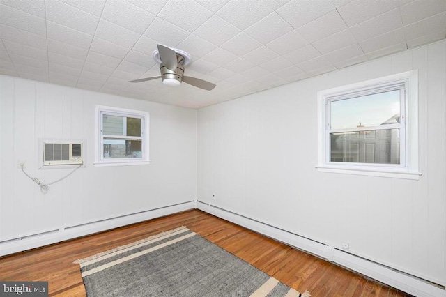 spare room featuring ceiling fan, a baseboard radiator, and hardwood / wood-style floors